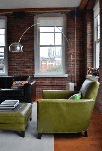 Olive leather armchairs in a library-style living room