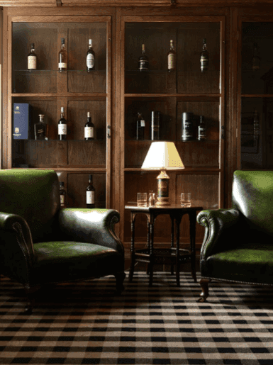 Olive leather seating in a brick-walled living room