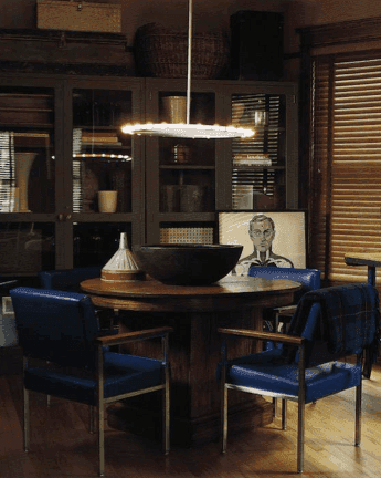 Dark blue chairs around a wooden dining table