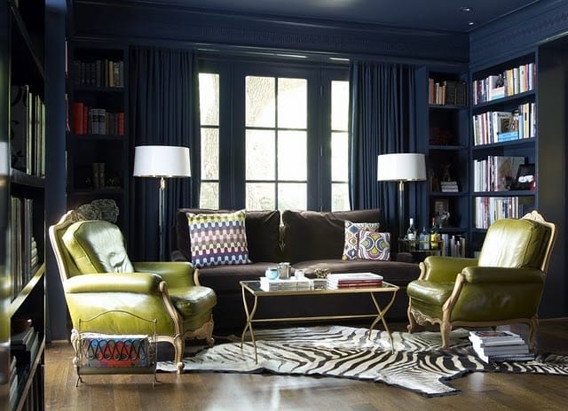 Olive leather armchairs in a library-style living room