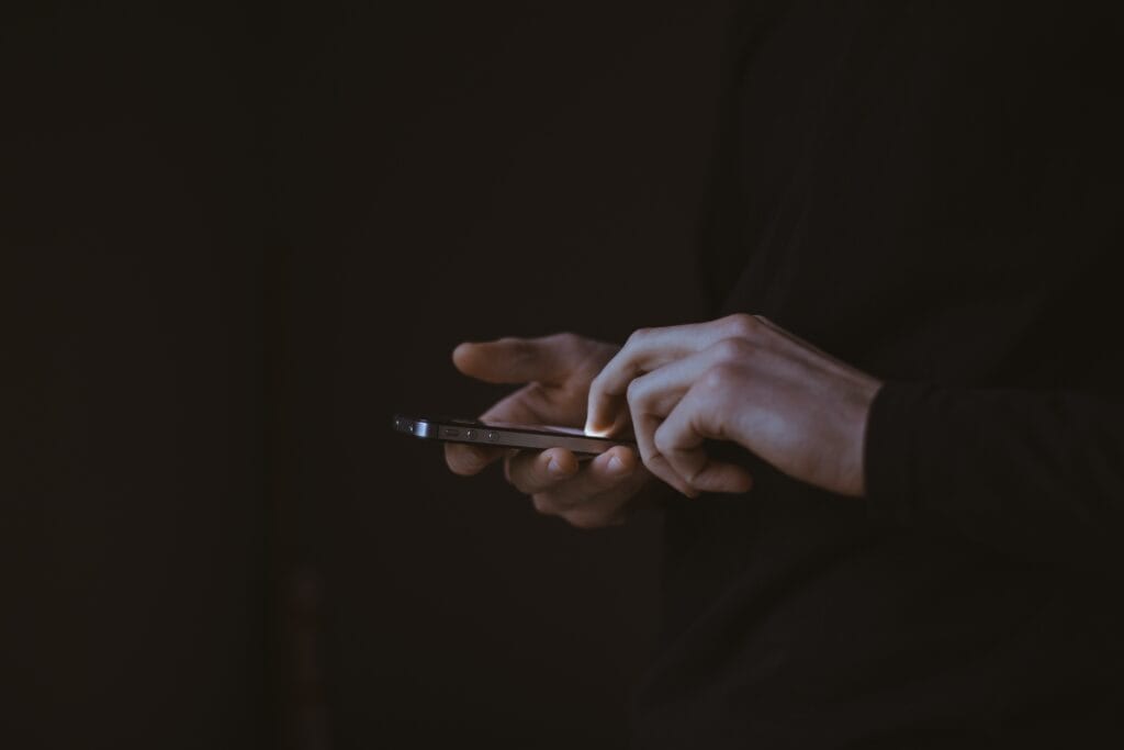 Hands using a mobile phone