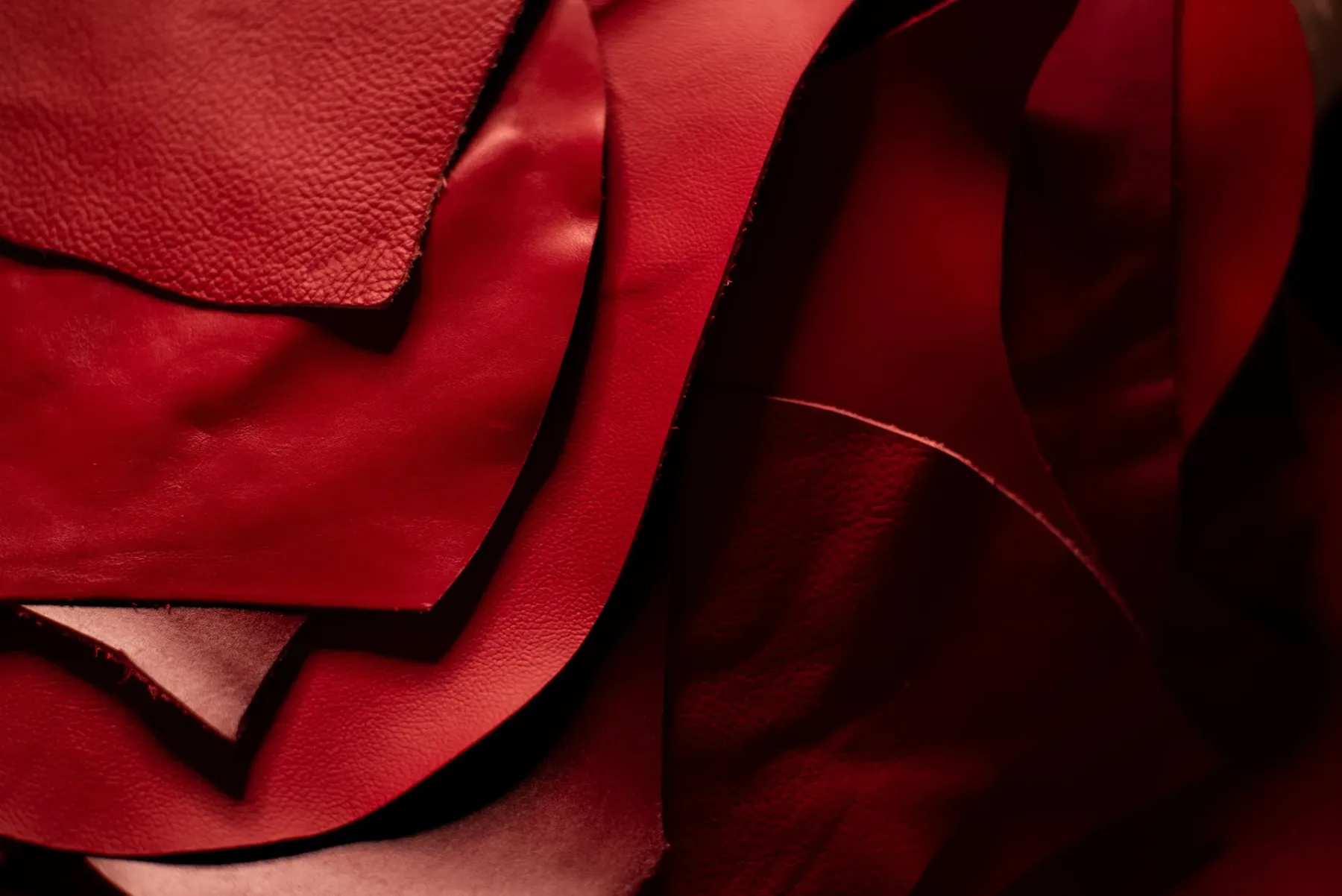 Leather swatches and creator tools on a work surface