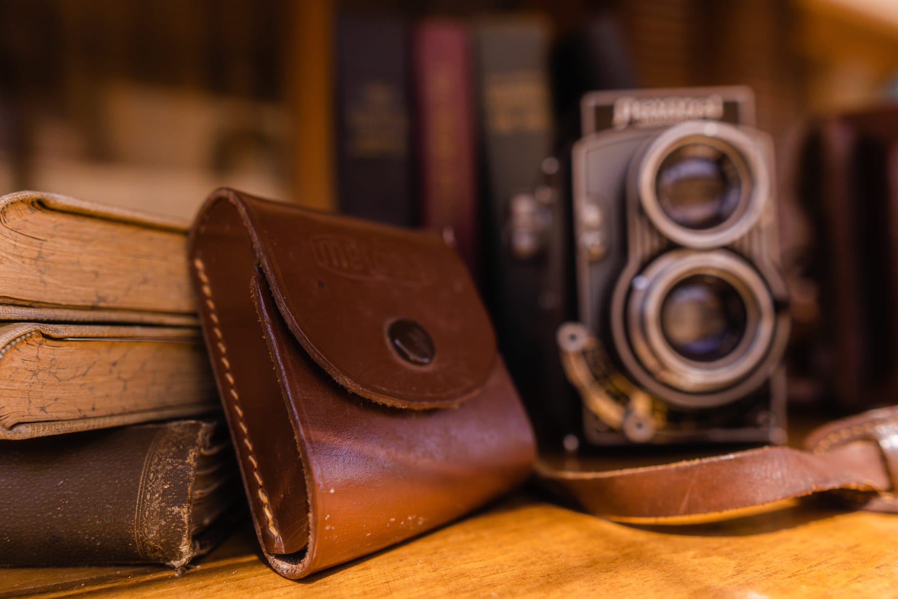 Vintage camera, leather case and books